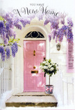 This doorway could easily belong to a tucked-away house near the green spaces of Cannon Hill in Raynes Park, captured at that tender moment when a new home still feels wonderfully fresh. A delicately painted pink door stands at the centre, its tone somewhere between blush and dusty rose, offering an immediate sense of warmth and character. The surrounding wall is whitewashed and clean, turning the entrance into a simple canvas for the flowers that dress it. From above, thick trails of wisteria sweep down in romantic cascades, brimming with small, clustered blossoms in shades of lavender and light violet. These flowering strands create a soft, whispering curtain that frames the door and casts feathery shadows in the natural light. Just by the threshold, slightly off to one side, rests a weathered-look grey bucket that has been artfully filled by a local florist. The bucket is packed full of white and cream roses, their petals layered and indulgent, opening like silk rosettes against the muted metal. Threaded through the roses are wisps of fresh greenery, adding subtle texture and a hint of woodland freshness. Around the bucket's base, a pale pink ribbon is tied neatly, its satin sheen catching the light and tying the whole colour story together with the door and wisteria overhead. The scene feels hushed and hopeful, as though the flowers have just been delivered to celebrate a move-in day, waiting to be carried inside between armfuls of boxes. It is a visual representation of blessing a new space with beauty and calm, the kind of thoughtful floral gesture Flower Delivery Raynes Park might prepare for same-day delivery to mark new beginnings and to say, in petals and perfume, welcome home.